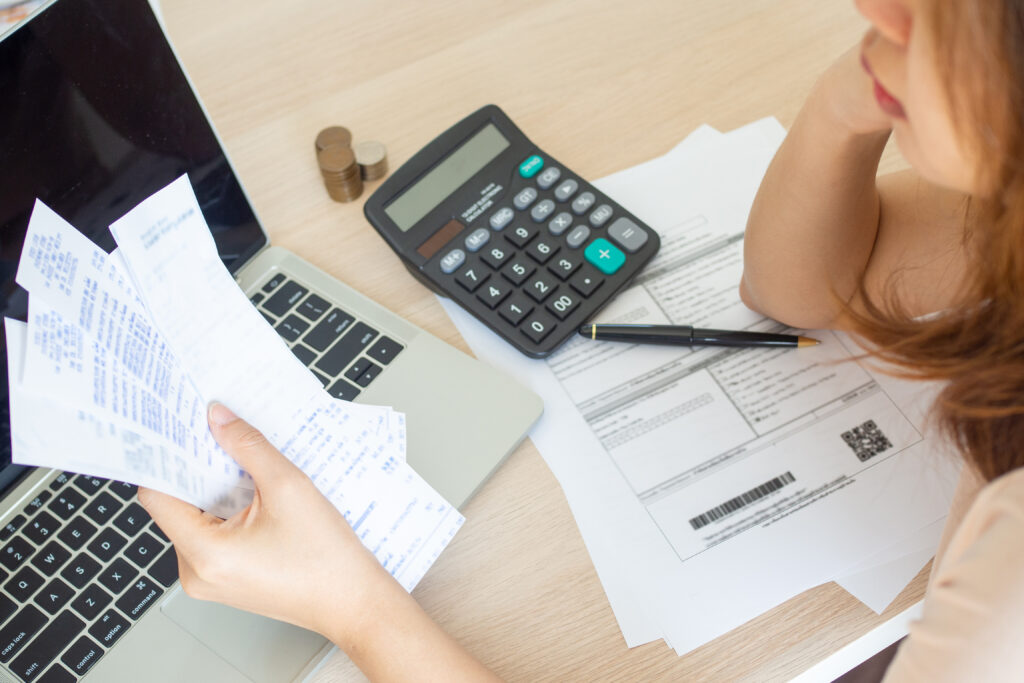 Asian Woman looking at receipts